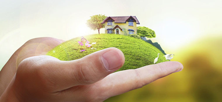 Close up of hands holding a house on a hill | Placing you in your own piece of paradise